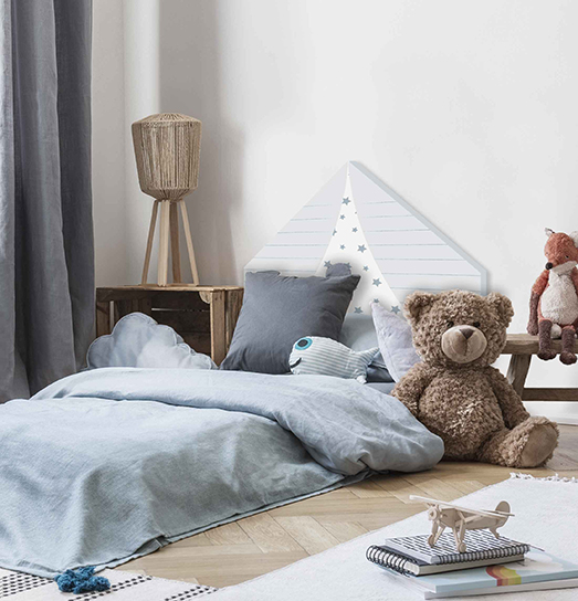 Pouf, rugs and plush toy in bright child's bedroom interior with